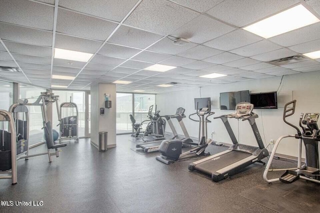 exercise room with a paneled ceiling