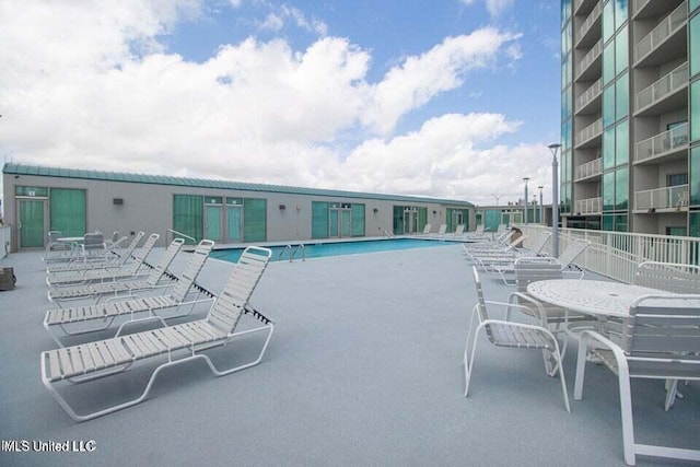 view of swimming pool featuring a patio area