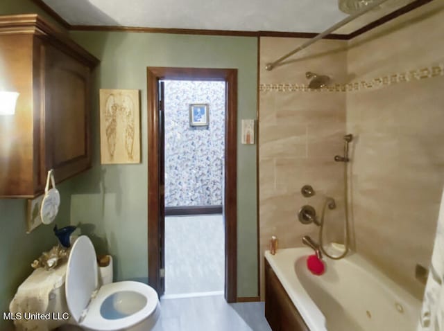 bathroom with toilet, crown molding, and tiled shower / bath combo