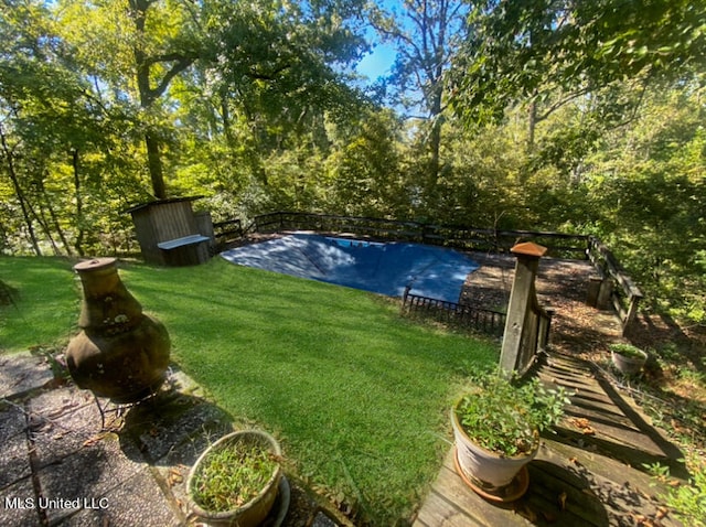 view of swimming pool with a lawn