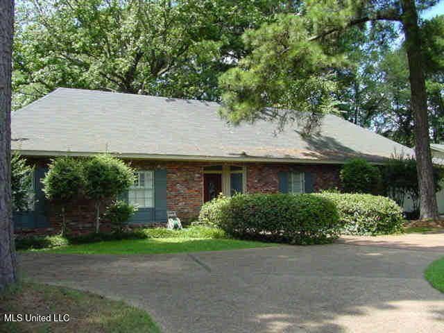 single story home featuring brick siding