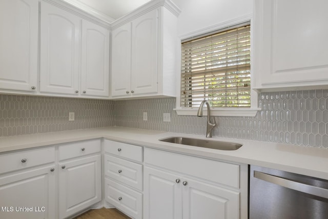 119 Middle Field Dr, Canton, MS 39046 - kitchen featuring dishwasher, a sink, tasteful backsplash, and white cabinetry