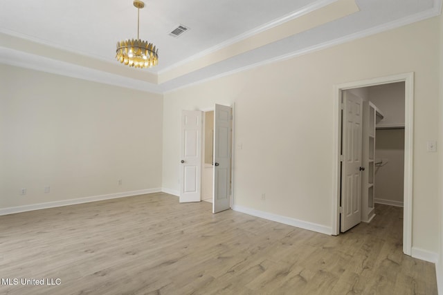 119 Middle Field Dr, Canton, MS 39046 - unfurnished bedroom with a chandelier, ornamental molding, light wood finished floors, a tray ceiling, and baseboards