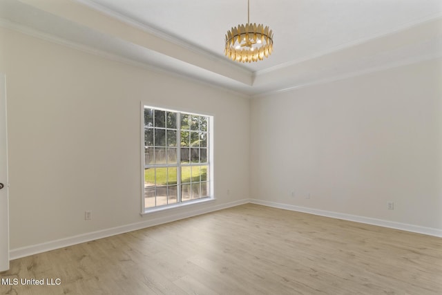 119 Middle Field Dr, Canton, MS 39046 - empty room with crown molding, a chandelier, light wood finished floors, baseboards, and a raised ceiling