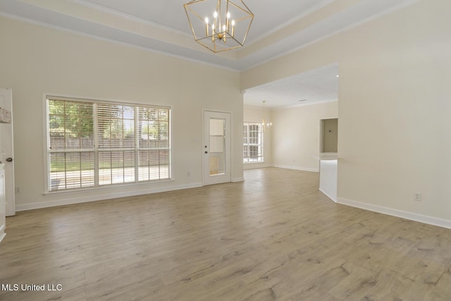 119 Middle Field Dr, Canton, MS 39046 - empty room with a chandelier, crown molding, light wood-type flooring, baseboards, and a tray ceiling