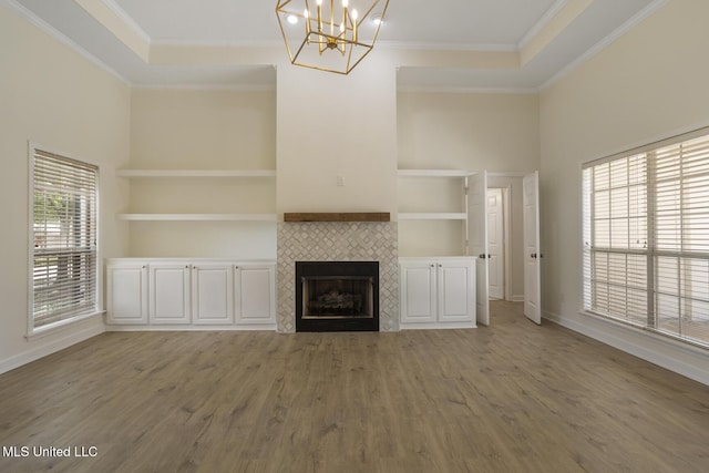 119 Middle Field Dr, Canton, MS 39046 - unfurnished living room featuring light wood-style flooring, crown molding, a chandelier, a tile fireplace, and baseboards