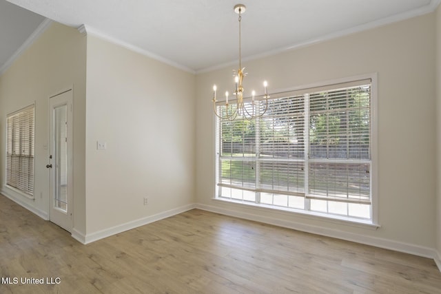 119 Middle Field Dr, Canton, MS 39046 - unfurnished dining area featuring a chandelier, ornamental molding, healthy amount of natural light, light wood finished floors, and baseboards