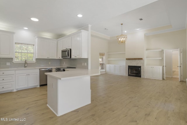 119 Middle Field Dr, Canton, MS 39046 - kitchen with appliances with stainless steel finishes, a sink, white cabinets, light countertops, and recessed lighting