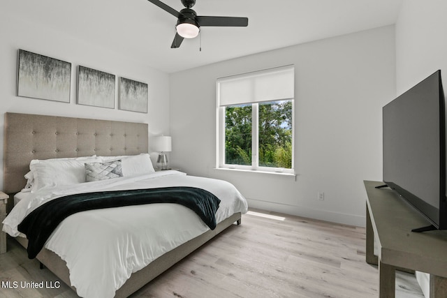 bedroom with ceiling fan and light hardwood / wood-style flooring