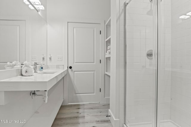 bathroom featuring vanity, an enclosed shower, and hardwood / wood-style flooring