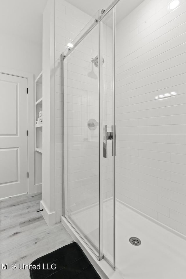 1302 Magnolia St Unit 109, Gulfport, MS 39501 - full bath featuring a stall shower and wood finished floors