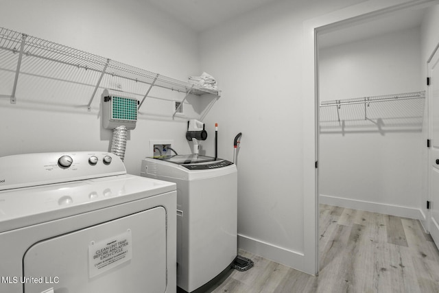 washroom featuring light hardwood / wood-style flooring and washer and clothes dryer