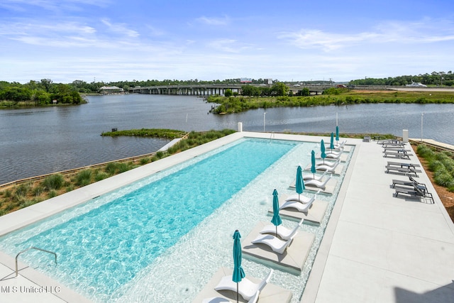 view of swimming pool with a water view