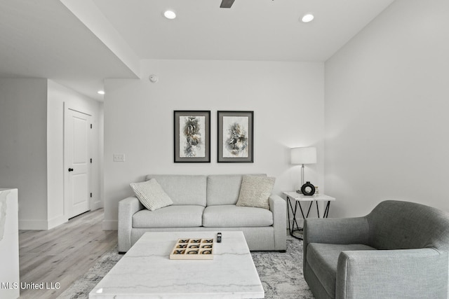 living room featuring light hardwood / wood-style floors and ceiling fan