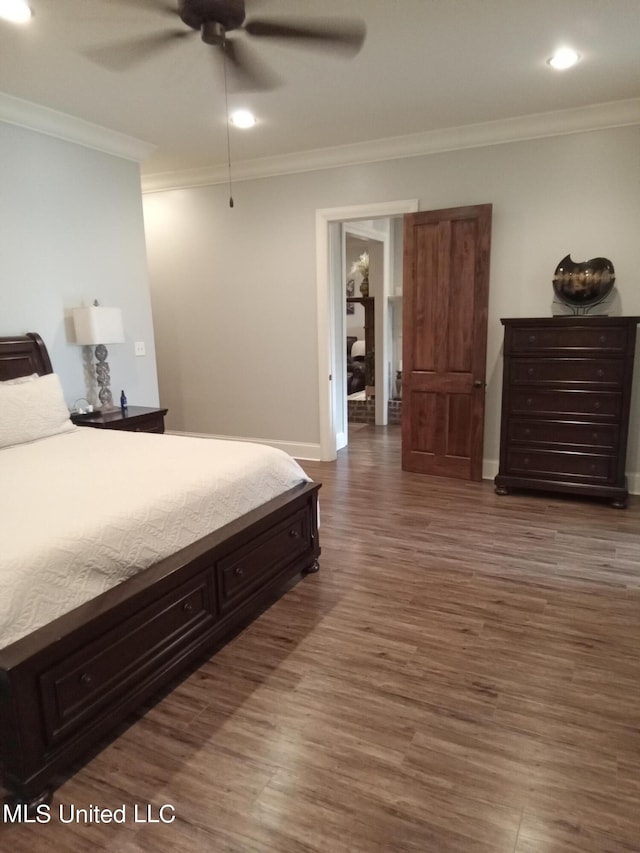 bedroom with ornamental molding, ceiling fan, and dark hardwood / wood-style flooring