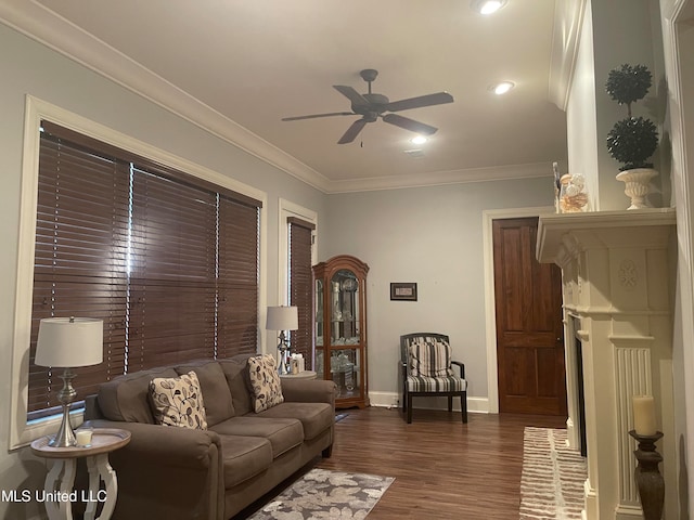 living room featuring dark wood-type flooring, ceiling fan, and crown molding