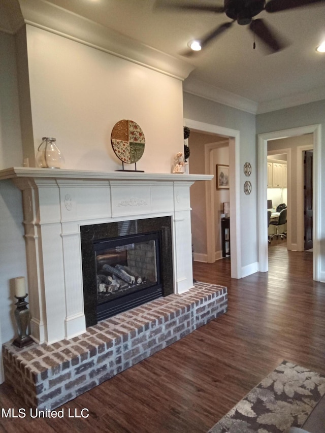 details featuring crown molding, wood-type flooring, a brick fireplace, and ceiling fan