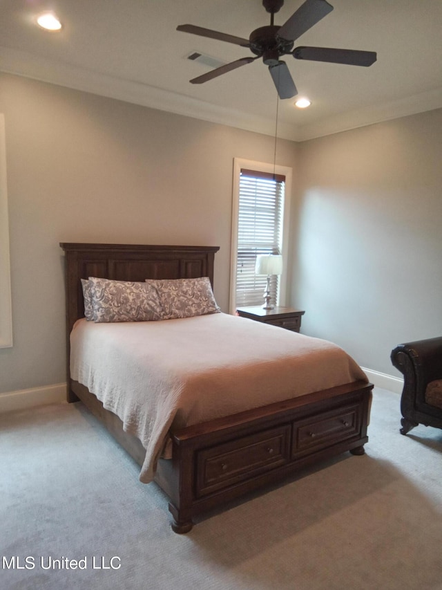 bedroom with ceiling fan, ornamental molding, and light colored carpet