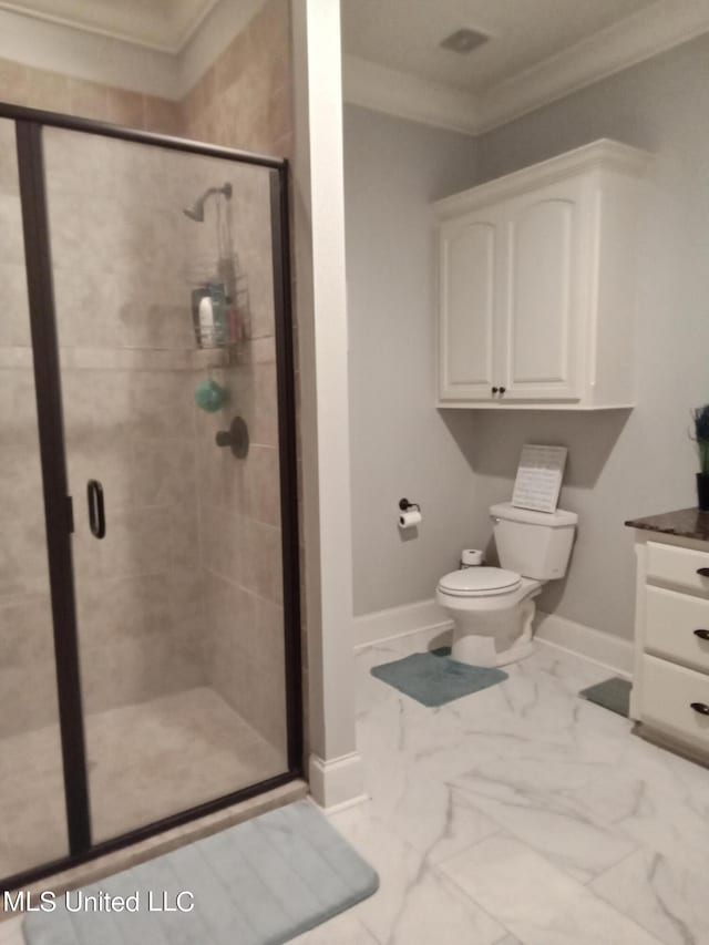 bathroom featuring vanity, toilet, crown molding, and a shower with shower door