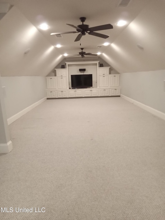 additional living space featuring lofted ceiling, light carpet, and ceiling fan