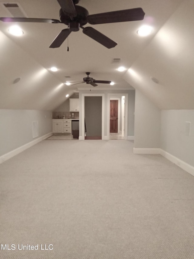 bonus room featuring light carpet, lofted ceiling, and ceiling fan