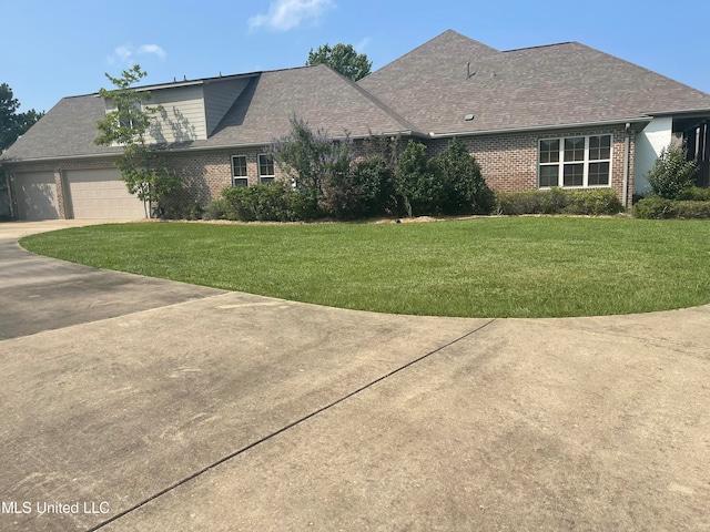 view of front facade with a front yard and a garage