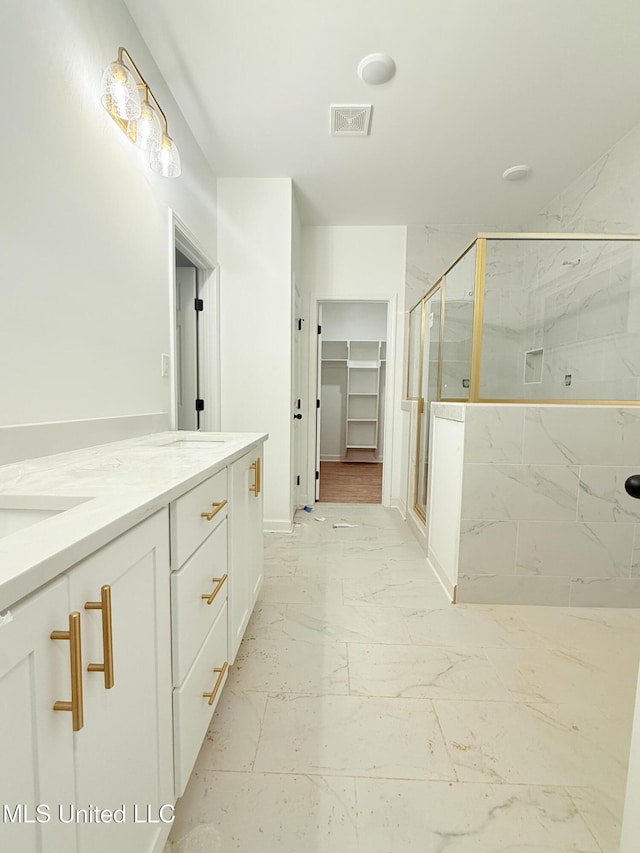 bathroom featuring an enclosed shower and vanity