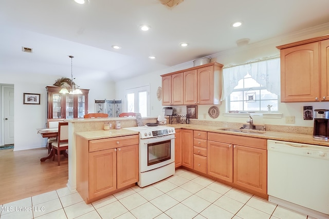 kitchen with pendant lighting, sink, light tile patterned floors, kitchen peninsula, and white appliances