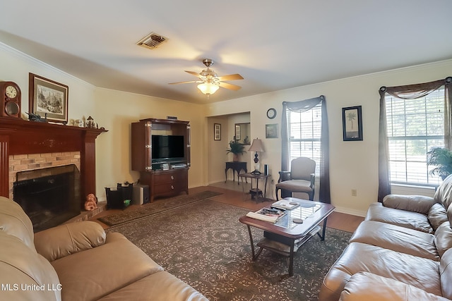 living room featuring dark hardwood / wood-style floors, a healthy amount of sunlight, a fireplace, and ceiling fan