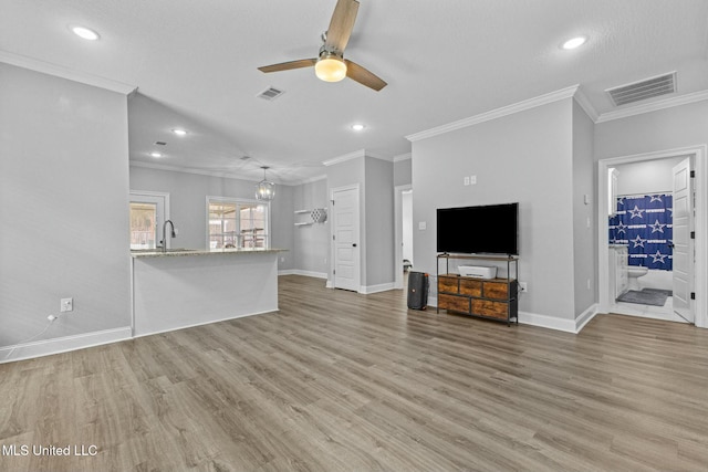 unfurnished living room featuring visible vents, light wood-style floors, and ceiling fan