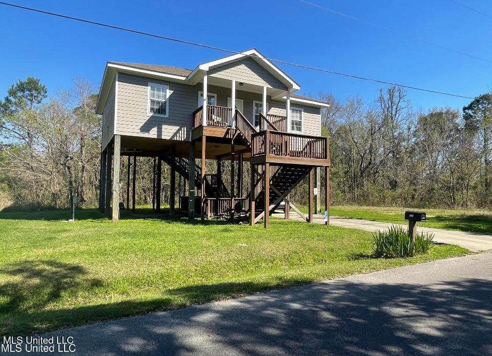 6102 Lepoma Ave, Biloxi, MS 39532 - beach home featuring stairs, covered porch, a front lawn, and driveway