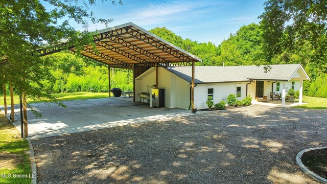 280 Bobby Ln, Picayune, MS 39466 - view of front of house featuring gravel driveway, a detached carport, and roof with shingles