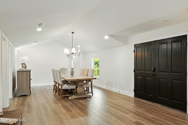 280 Bobby Ln, Picayune, MS 39466 - dining area featuring baseboards, wood finished floors, a chandelier, vaulted ceiling, and recessed lighting