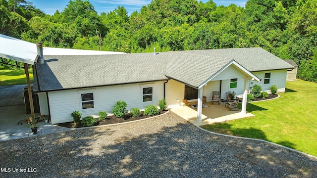 280 Bobby Ln, Picayune, MS 39466 - view of front of property with a front lawn, a patio area, a shingled roof, and a forest view