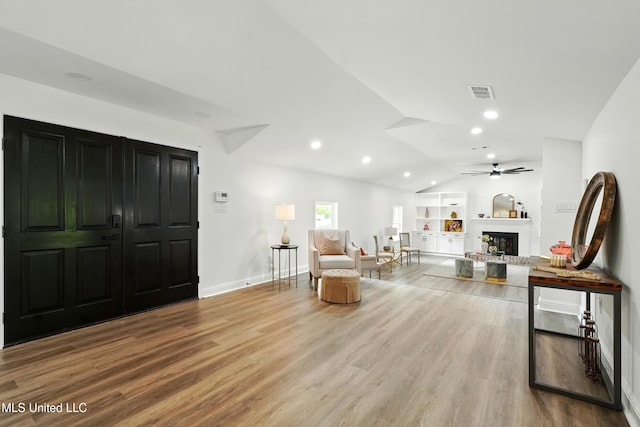 280 Bobby Ln, Picayune, MS 39466 - living area with wood finished floors, a glass covered fireplace, vaulted ceiling, a ceiling fan, and baseboards