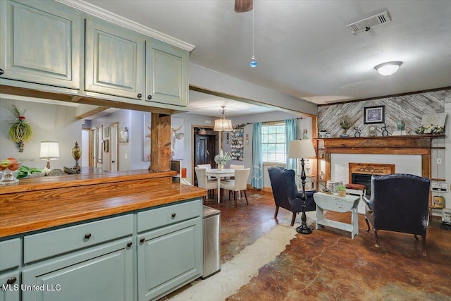 1563 Dry Creek Rd, Magee, MS 39111 - kitchen with butcher block countertops, finished concrete flooring, green cabinetry, a brick fireplace, and open floor plan