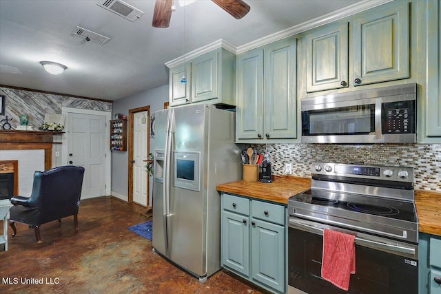 1563 Dry Creek Rd, Magee, MS 39111 - kitchen with stainless steel appliances, wood counters, tasteful backsplash, and a ceiling fan