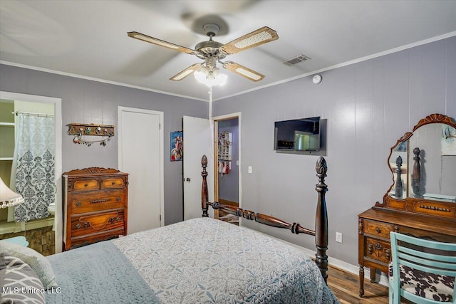 1563 Dry Creek Rd, Magee, MS 39111 - bedroom with wood finished floors, crown molding, baseboards, a ceiling fan, and connected bathroom