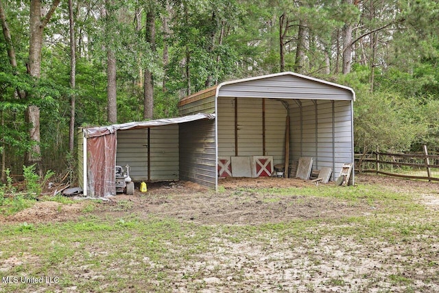 1563 Dry Creek Rd, Magee, MS 39111 - view of outbuilding with a detached carport and a view of trees