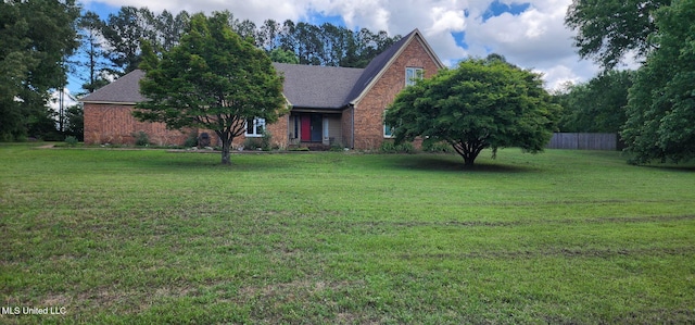 view of front of property featuring brick siding and roof with shingles
