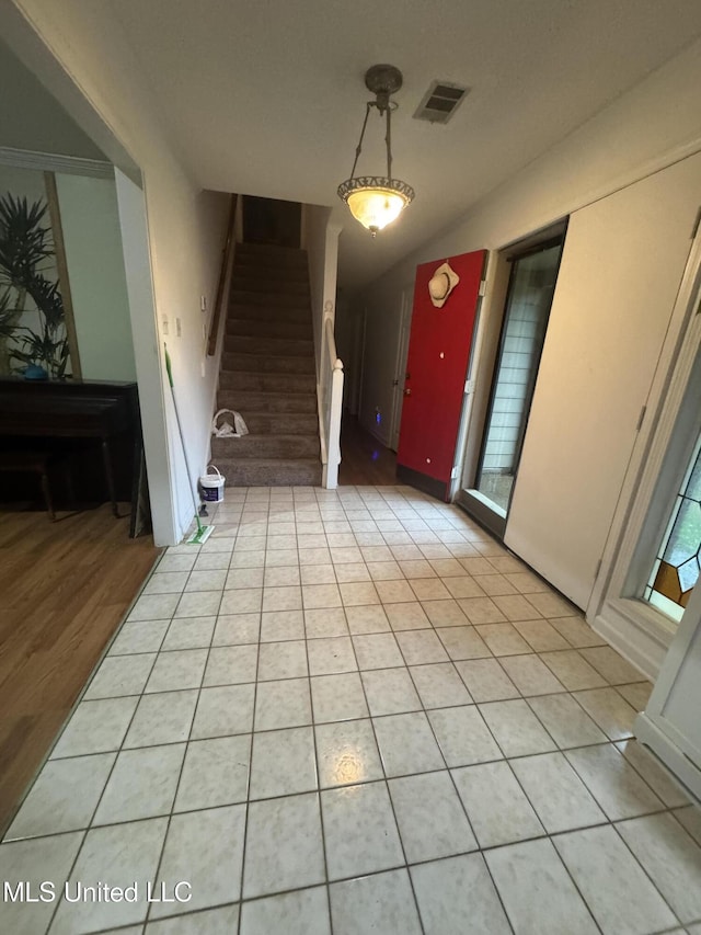 entryway featuring stairs and vaulted ceiling