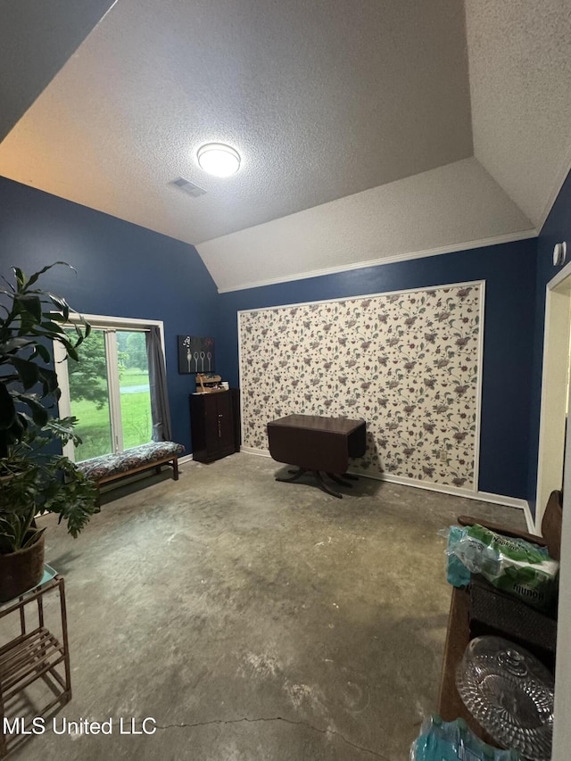 bedroom with vaulted ceiling and a textured ceiling