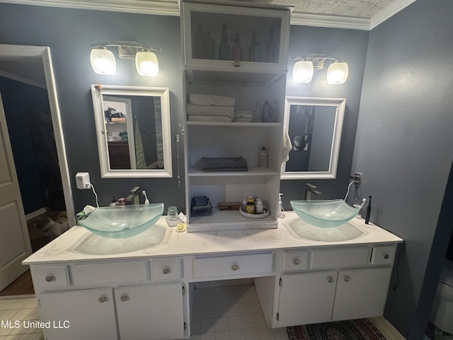 bathroom featuring ornamental molding, tile patterned flooring, and double vanity