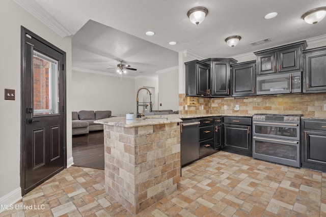 kitchen with light stone countertops, appliances with stainless steel finishes, tasteful backsplash, crown molding, and sink