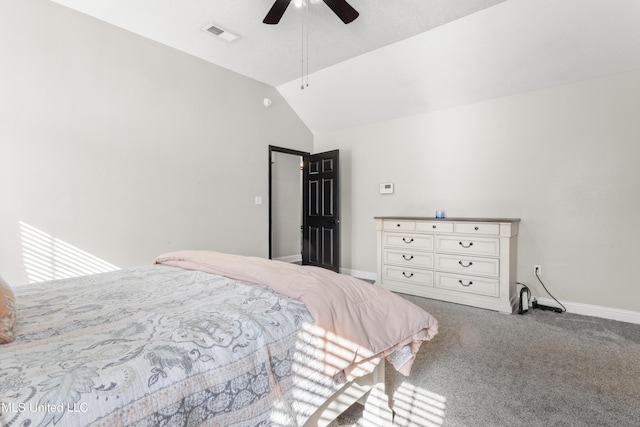 carpeted bedroom with ceiling fan and vaulted ceiling