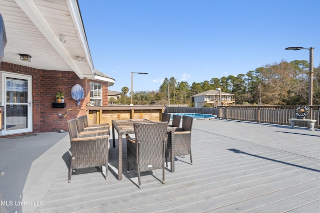 wooden deck with a covered pool