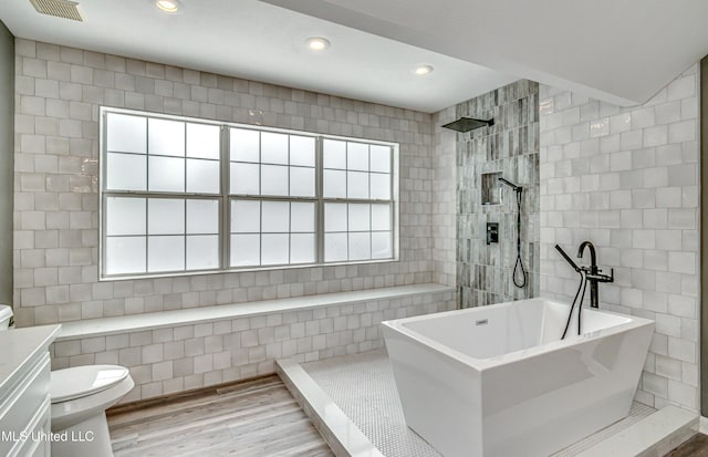 363 Lake Harbor Rd, Brandon, MS 39047 - bathroom with a freestanding bath, wood finished floors, plenty of natural light, a walk in shower, and recessed lighting