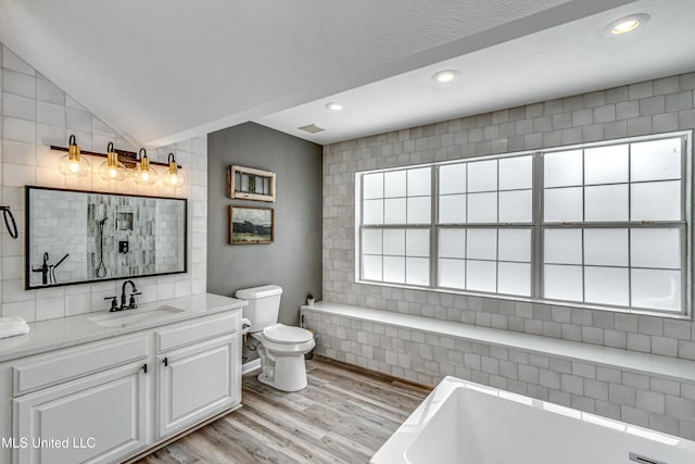 363 Lake Harbor Rd, Brandon, MS 39047 - full bath with wood finished floors, a bath, toilet, vanity, and recessed lighting