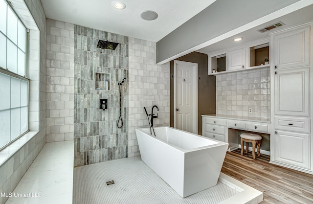 363 Lake Harbor Rd, Brandon, MS 39047 - bathroom with a freestanding tub, a walk in shower, healthy amount of natural light, wood finished floors, and recessed lighting