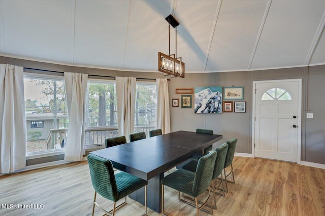 363 Lake Harbor Rd, Brandon, MS 39047 - dining area with a chandelier, lofted ceiling, light wood-style floors, and baseboards